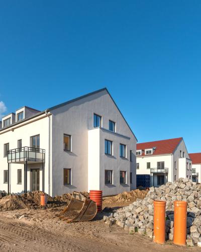 Baustelle Neubau Einfamilienhaus in einer Siedlung.
